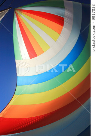 The wind has filled colorful spinnaker sail 9917038
