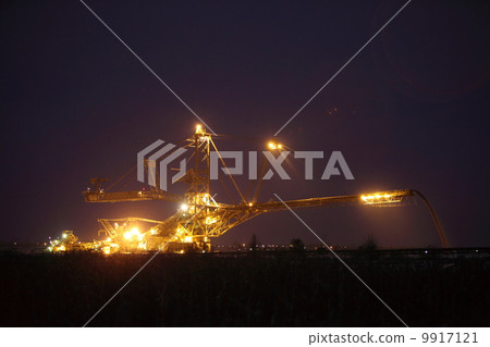 giant excavator in a coal open pit evening giant excavator in a coal open pit evening 9917121