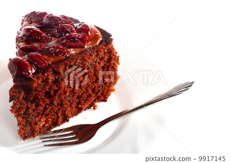 Piece of chocolate cake with icing and cherry Piece of chocolate cake with icing and cherry 9917145