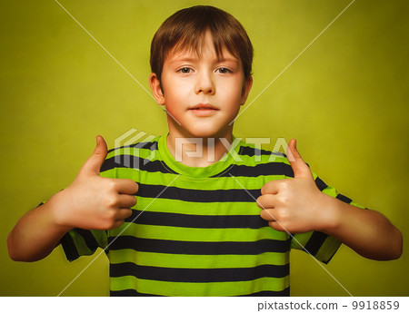 blonde boy kid in shirt holding thumbs up, showing sign yes emot blonde boy kid in shirt holding thumbs up, showing sign yes emot 9918859