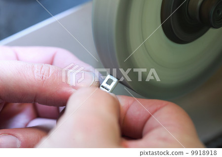 hands of jeweller at work. Silver polishing. hands of jeweller at work. Silver polishing. 9918918