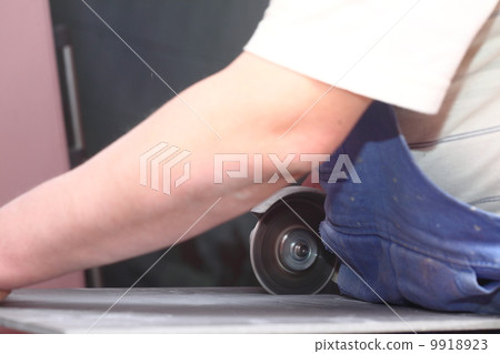 grinder worker cuts a stone the electric tool grinder worker cuts a stone the electric tool 9918923