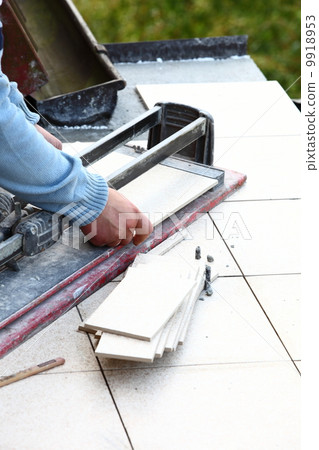 man cutting tile by cutter man cutting tile by cutter 9918953