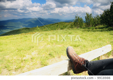 Hiking shoes. Hiker enjoying view relaxing 9918986