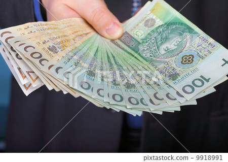 Businessman holding money polish banknote Businessman holding money polish banknote 9918991