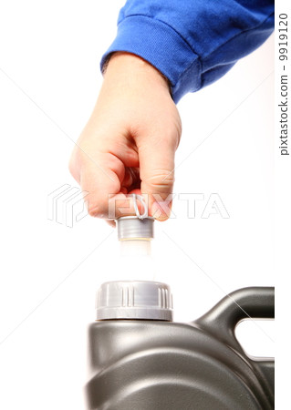 hand opening can with car engine oil isolated hand opening can with car engine oil isolated 9919120