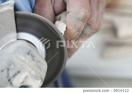 construction worker using an angle grinder cutting tile construction worker using an angle grinder cutting tile 9919122