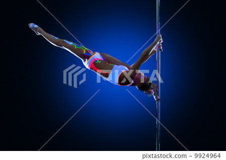 Athletic young woman posing doing splits on pylon Athletic young woman posing doing splits on pylon 9924964