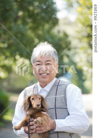 Senior holding a dog Senior holding a dog 9925869