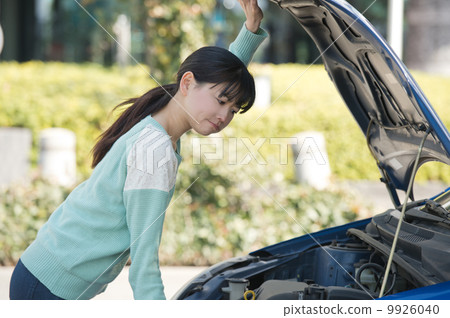 A woman in need of opening the hood A woman in need of opening the hood 9926040