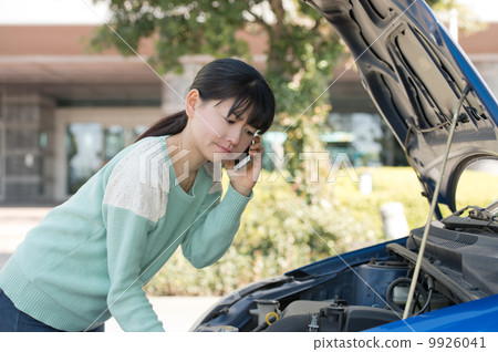 A woman in need of opening the hood A woman in need of opening the hood 9926041