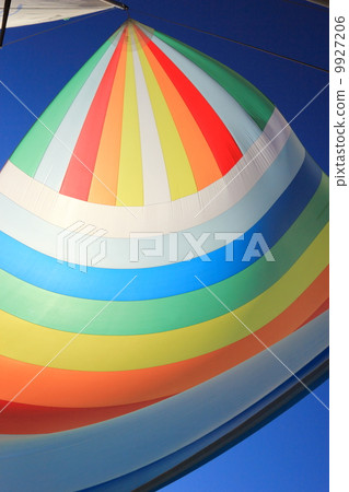 The wind has filled colorful spinnaker sail 9927206