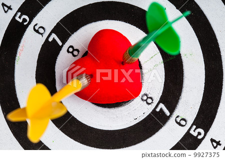 Black white target with two darts in heart love symbol as bullseye 9927375