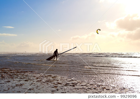 kitesurfer on beach in waves 9929096