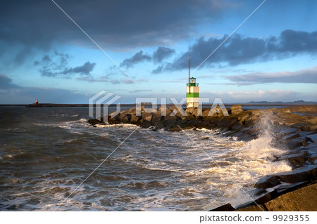 North sea waves and lighthouse in Ijmuiden, Holland North sea waves and lighthouse in Ijmuiden, Holland 9929355