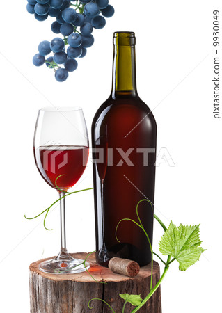 Glass of red wine, bottle and grape on stump isolated on white 9930049