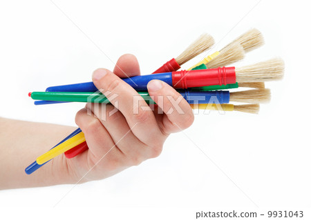 Female hand holding colorful brushes for drawing, isolated over 9931043