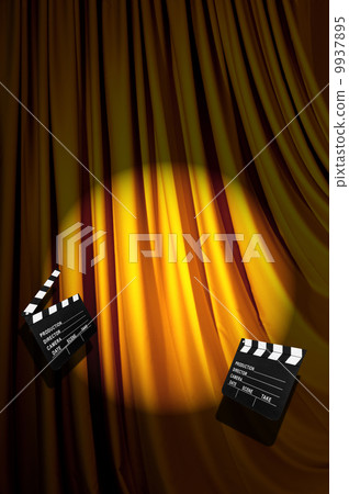 Movie clapper board against curtain 9937895