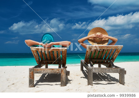 Couple in green on a beach at Maldives 9939986