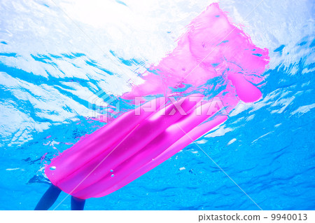 Woman relaxing on inflatable mattress, view from underwater 9940013