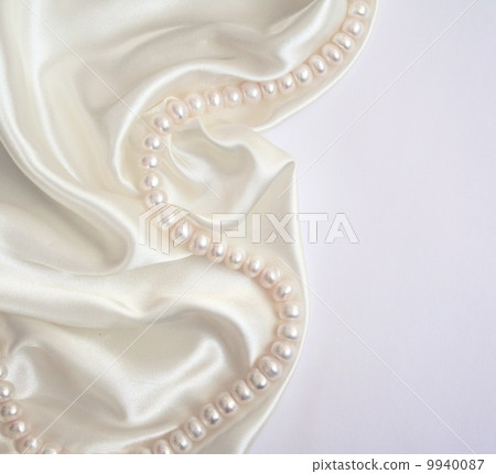 Smooth elegant white silk with pearls as wedding background 9940087