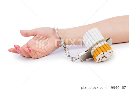 Addition concept with cigarettes and handcuffs Addition concept with cigarettes and handcuffs 9940467