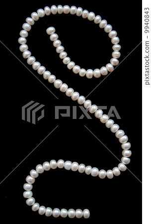 White pearls on the black silk 9940843