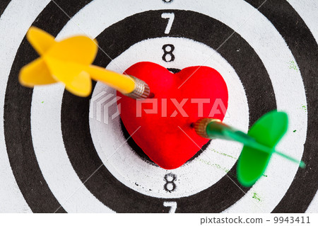 Black white target with two darts in heart love symbol as bullseye 9943411