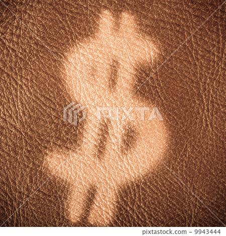 dollar sign on brown leather background. Economy and finance. 9943444