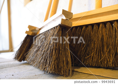 large brooms on wooden floor housework 9943691