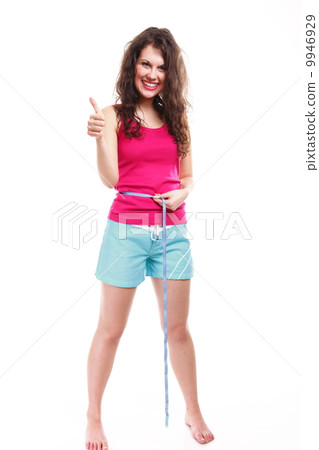 sporty fit woman with measure tape thumbs up 9946929