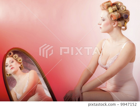 sexy girl in underwear curlers preparing to party looking at mirror sexy girl in underwear curlers preparing to party looking at mirror 9947152