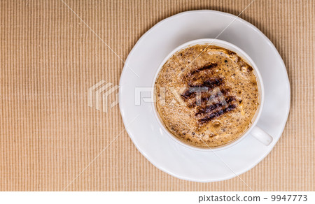White cup coffe hot beverage drink with froth on brown background 9947773