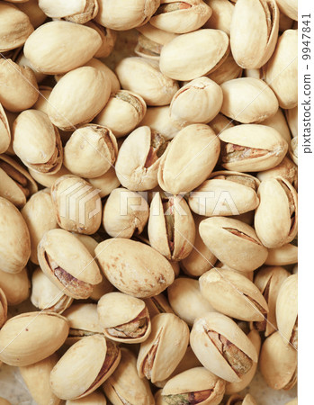 Closeup of pistachios in nut shells as food background Closeup of pistachios in nut shells as food background 9947841