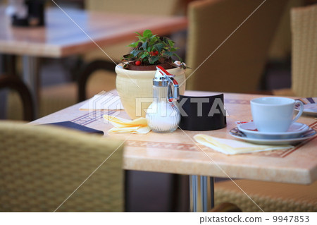 Outdoor restaurant cafe table with coffee cup Outdoor restaurant cafe table with coffee cup 9947853