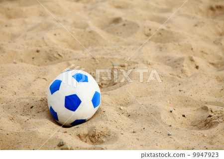 soccer ball on sandy beach background 9947923