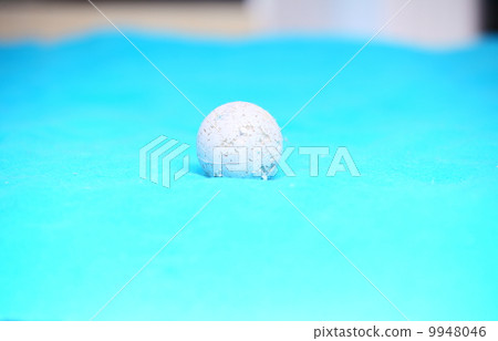 Old white ball toy for pets playing on bed 9948046