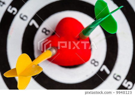 Black white target with two darts in heart love symbol as bullseye 9948123
