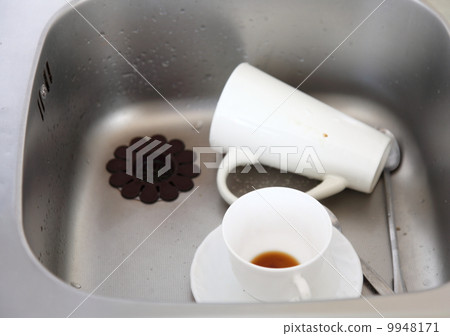 Dishwashing. White dishes in the kitchen sink. Dishwashing. White dishes in the kitchen sink. 9948171
