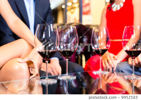 Asian Friends drinking wine in bar 9952583