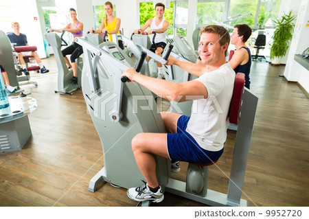 People in sport gym on machines 9952720