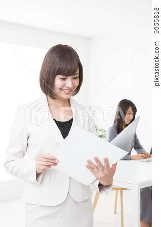 A woman holding a file at the office 9953818