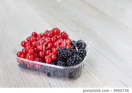 Bowl with different berries - red currant and blackberry 9960736