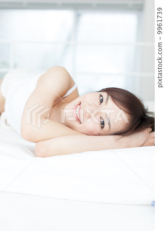 A woman lying on the bed 9961739