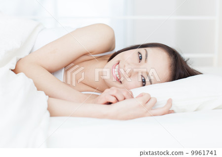 A woman sleeping in bed A woman sleeping in bed 9961741