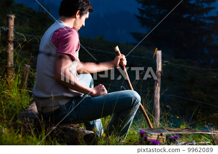Alps - Man at campfire in Bavarian mountains 9962089