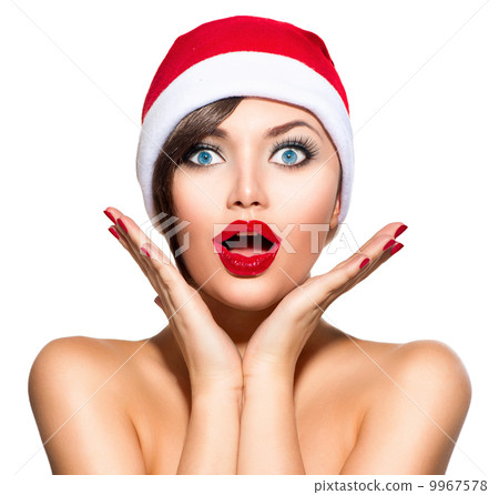 Christmas Woman. Beauty Model Girl in Santa Hat over White 9967578