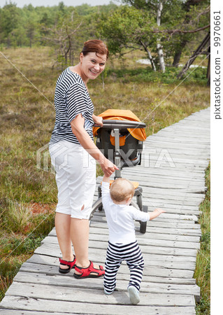 Little baby boy making his first steps with mother Little baby boy making his first steps with mother 9970661