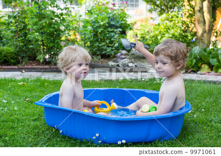 Two sibling boys having fun with water in summer Two sibling boys having fun with water in summer 9971061