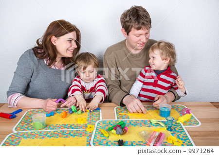 Happy family of a four having fun at home Happy family of a four having fun at home 9971264